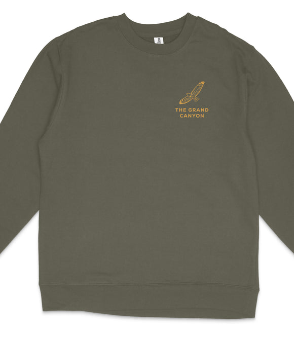A dark green long-sleeved shirt with a logo on the left side.