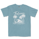 a blue t - shirt with a picture of a wave and palm trees