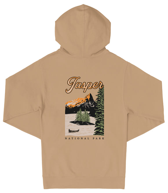 A beige hooded sweatshirt with a graphic design depicting a scenic landscape with mountains, pine trees, and a small boat on a lake.