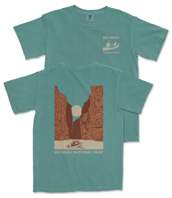 A turquoise t-shirt with a graphic design depicting a canyon and a boat, along with the text "BIG BEND NATIONAL PARK" printed on it.