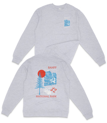 a grey sweatshirt with a graphic design on the back, depicting a mountain landscape with a red sun and blue sky.