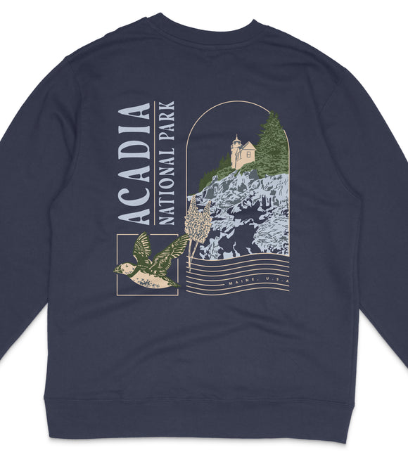 a navy blue sweatshirt with a graphic design depicting a lighthouse, a bird, and a mountain landscape.