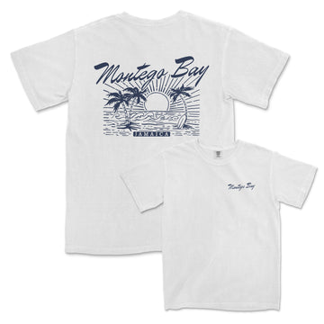a white t - shirt with a picture of a sunset and palm trees