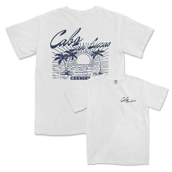 a white t - shirt with a picture of a sunset and palm trees