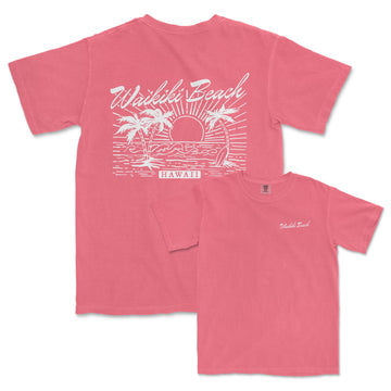 a pink t - shirt with a sunset and palm trees on it