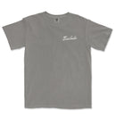 a grey t - shirt with an embroidered logo on the chest