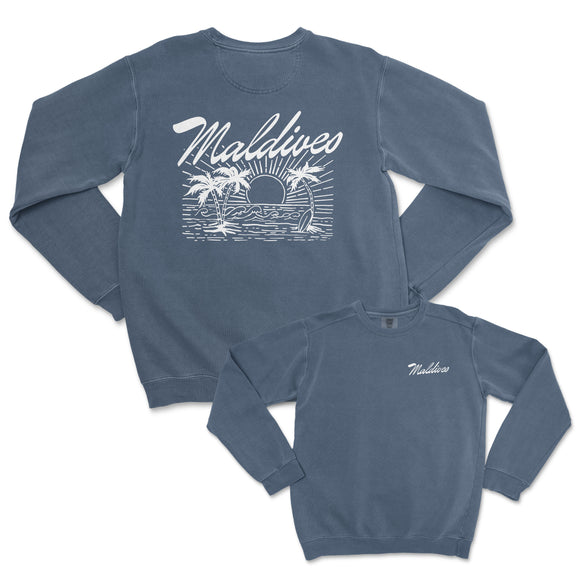 a blue sweatshirt with a palm tree and a sunset on it