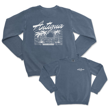 a blue long sleeve shirt with an image of a boat and palm trees