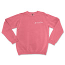 a pink sweatshirt with a white writing on it