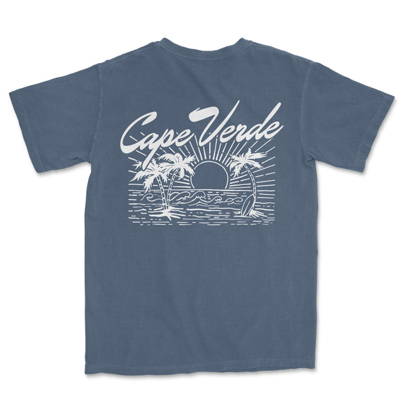a blue t - shirt with a picture of a boat and palm trees